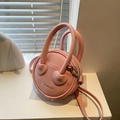 Minimalist light pink round crossbody bag in lychee pattern leather with dual handles - Pink