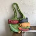Grass green knitted tote bag featuring colorful plush fish charms and hollow weave texture - Green