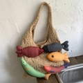Handmade beige knit tote bag with colorful fabric fish charms for a casual holiday look - Khaki