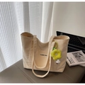 Off-white canvas tote bag with black TAIMEI text and yellow sunflower charm detail - Beige With Charm