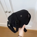 Minimalist black nylon crossbody bag featuring three zipper pockets and wide strap - Black