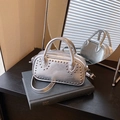 Silver metallic crossbody bag with round top handles and decorative metal rivets finish - Silver