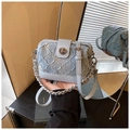 Detailed view of light blue denim pleated crossbody bag with silver clasp and chain handle - Blue with Charm