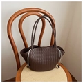 Detailed texture of dark brown woven tote bag on a wooden chair with drawstring side detail - Brown
