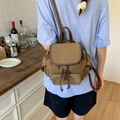 Brown canvas drawstring backpack with vintage leather trim shown on a model's back - Khaki