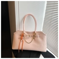 Detail of light pink leather tote bag featuring golden metal chain and woven rope accent - Pink with Pendant