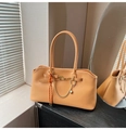 Detail of vintage orange-brown tote bag with metal chain, heart pendant and woven charm - Yellow Brown With Pendant
