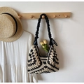Detail of crochet knit shoulder bag with hollow floral pattern and ruffled black strap - Black