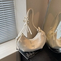 Cream pleated crescent shoulder bag featuring silver bow hardware and knotted strap details - Off-white