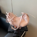 Pink crescent shoulder bag with ribbon design and glossy faux leather finish - Pink