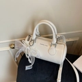 Elegant off-white cylindrical bucket bag featuring pearl chains and mesh bow detail - Cream White With Pendant