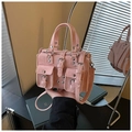 Detailed view of pink multi-pocket handbag with silver rivets and buckled straps - Pink
