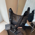Black nylon crescent crossbody bag with multiple zippers and wide adjustable strap - L Black