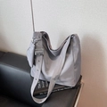 Minimalist light grey nylon tote bag with wide shoulder strap and small matching pouch - Gray