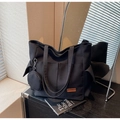 Detail of black canvas tote bag with multi-pockets and a small round coin purse attachment - Black