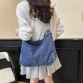 Blue washed denim hobo bag worn by model, oversized casual crossbody shoulder bag - Blue