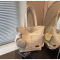 Close-up of minimalist off-white canvas tote bag with side pockets and a round coin purse - Off-white