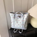 White canvas tote bag with red bow print and light blue faux leather trim accents - Blue
