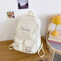 Detailansicht des cremefarbenen Schulrucksacks mit vielen Taschen und Stern-Plüschdekor - Weiß