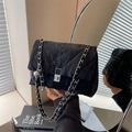 Glossy black quilted crossbody bag with silver chain strap and metal turn-lock closure - Black