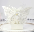 Intricate laser-cut butterfly gift box with floral patterns on a gold-rimmed ceramic plate - Ivory