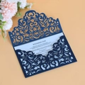 Laser cut navy blue wedding invitation suite with intricate filigree on a light background - Magic Blue