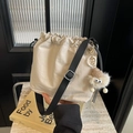 Chic beige nylon bucket bag with drawstring closure and cute plush charm pendant - Beige With Charm