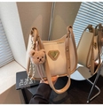 Detail of cream PU leather bucket bag with brown trim and plush bear charm decoration - With Charm / Off White