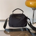 Minimalist black nylon crossbody handbag with adjustable wide strap and circular logo detail - Black