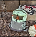 Nahaufnahme grüner Wanderrucksack mit Netztasche und orangefarbenen Reißverschlüssen - Grün