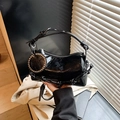 Minimalist black patent leather Boston handbag with glossy finish and silver rivet charm - Black