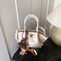 Chic beige dumpling handbag with silver buckle, brown mini charm and shoulder strap - With Pendant / White