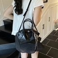 Fashionable black faux leather dumpling handbag with adjustable crossbody strap and charm - With Pendant / Black