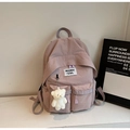 Close-up of canvas backpack with nylon texture, front pockets and plush bear charm - With Charm / Purple
