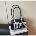 Black patent leather shoulder bag featuring large white lace bows and silver heart charm - Black with Pendant