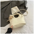 Detail of cream white bucket bag with crocodile texture and cute teddy bear charm accessory - White With Pendant