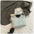Detail of light blue crocodile pattern bucket bag with bear pendant and silk ribbon decor - Blue with Pendant