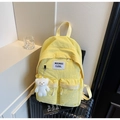 Bright yellow canvas backpack with dual front pockets and cute white plush bear charm - With Charm / Yellow