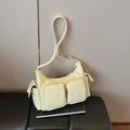 Pale yellow patent leather underarm bag with multi-pocket utilitarian design and silver hardware - Yellow