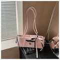 Detail of pink shoulder bag featuring black bows and heart pendant in a chic setting - Pink