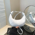 White crescent crossbody bag with lychee texture and knot detail on the shoulder strap - White