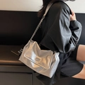 Silver wrinkled leather shoulder bag with metallic chain strap worn by a model - Silver