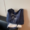 Dark blue tote bag with white bow and Protect your Heart slogan with adjustable strap - Dark Blue