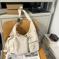 Beige large capacity vintage messenger bag with multiple pockets in utility style - Off White