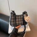 Grey and black checkered crescent shoulder bag with a cute brown plush bear keychain - Black