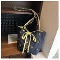 Detail of navy denim tote bag with yellow floral embroidery and a plaid ribbon bow - Dark Blue
