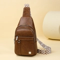 Brown leather chest bag featuring three zip pockets and geometric patterned strap - Brown