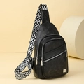 Compact black matte chest bag with geometric patterned strap on a minimalist pedestal - Black