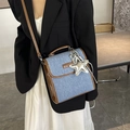 Vintage denim handbag with brown leather trim and star charm shown on model - Brown (With Charm)