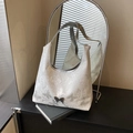 White butterfly printed shoulder bag with metallic buckle on a stylish studio setting - Silver